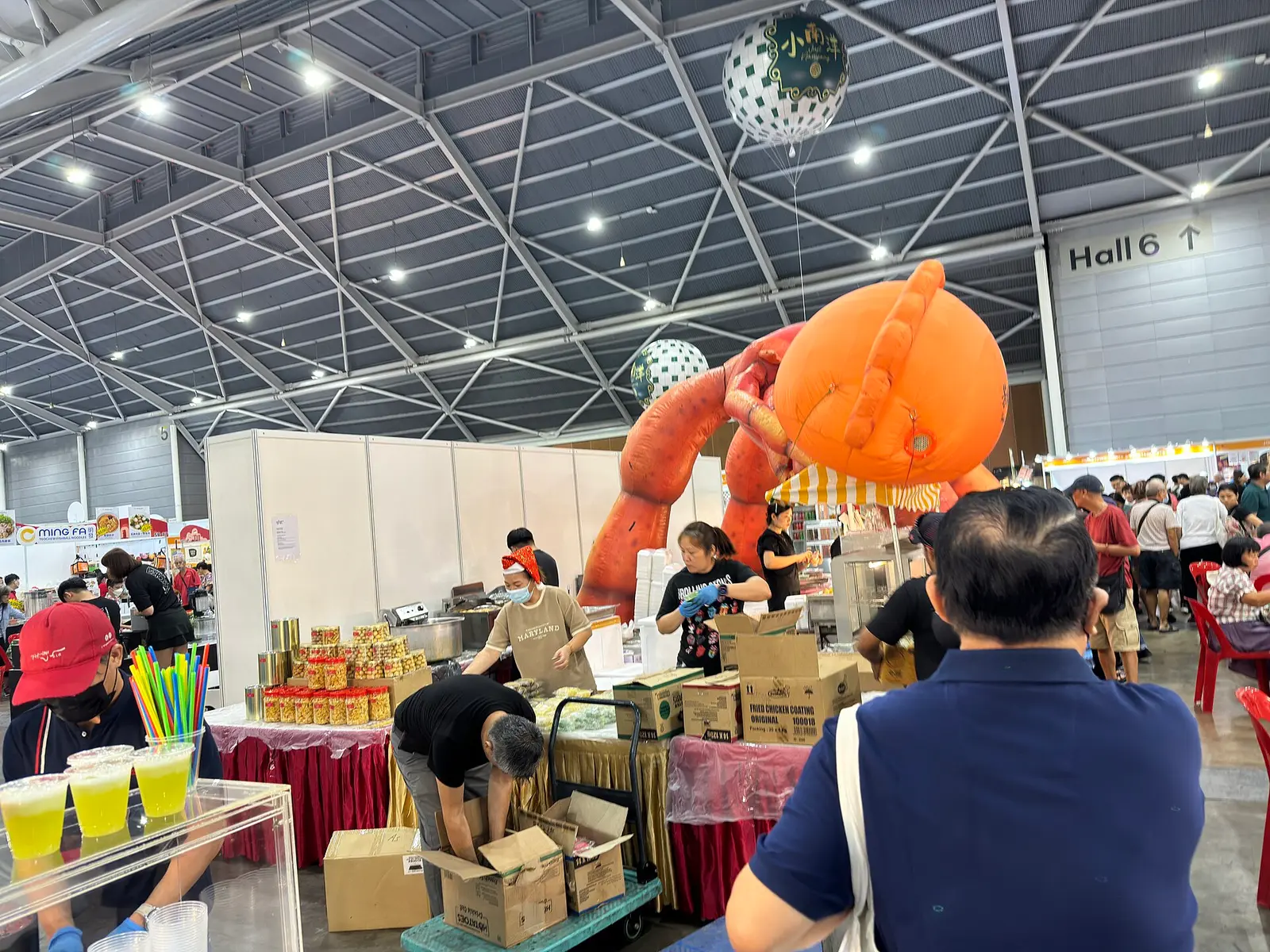 Exhibition stalls and visitors inside a hall at Singapore Expo during the Asia Pacific Food Expo in December 2024
