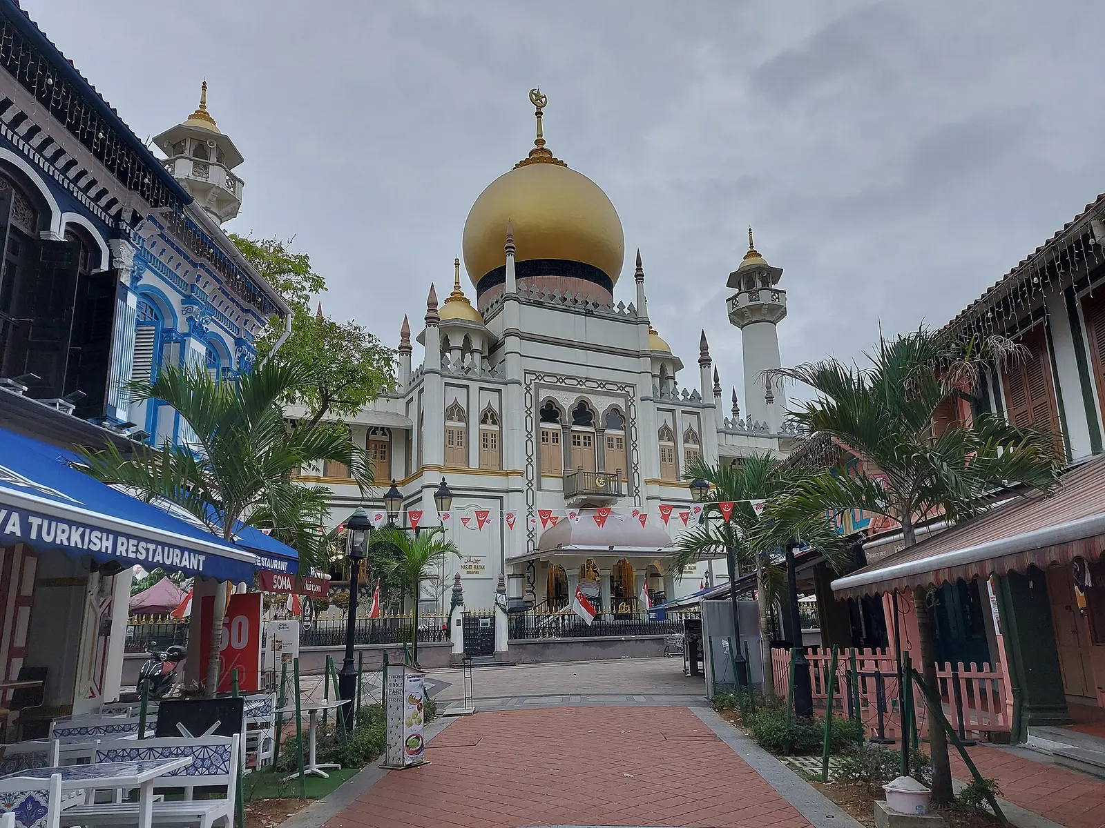 Golden-domed Sultan Mosque seen down the shophouse-lined street in Kampong Glam